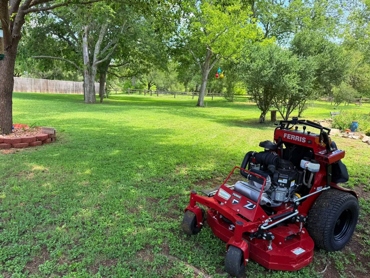 Ferris mower on a large shaded acreage lot