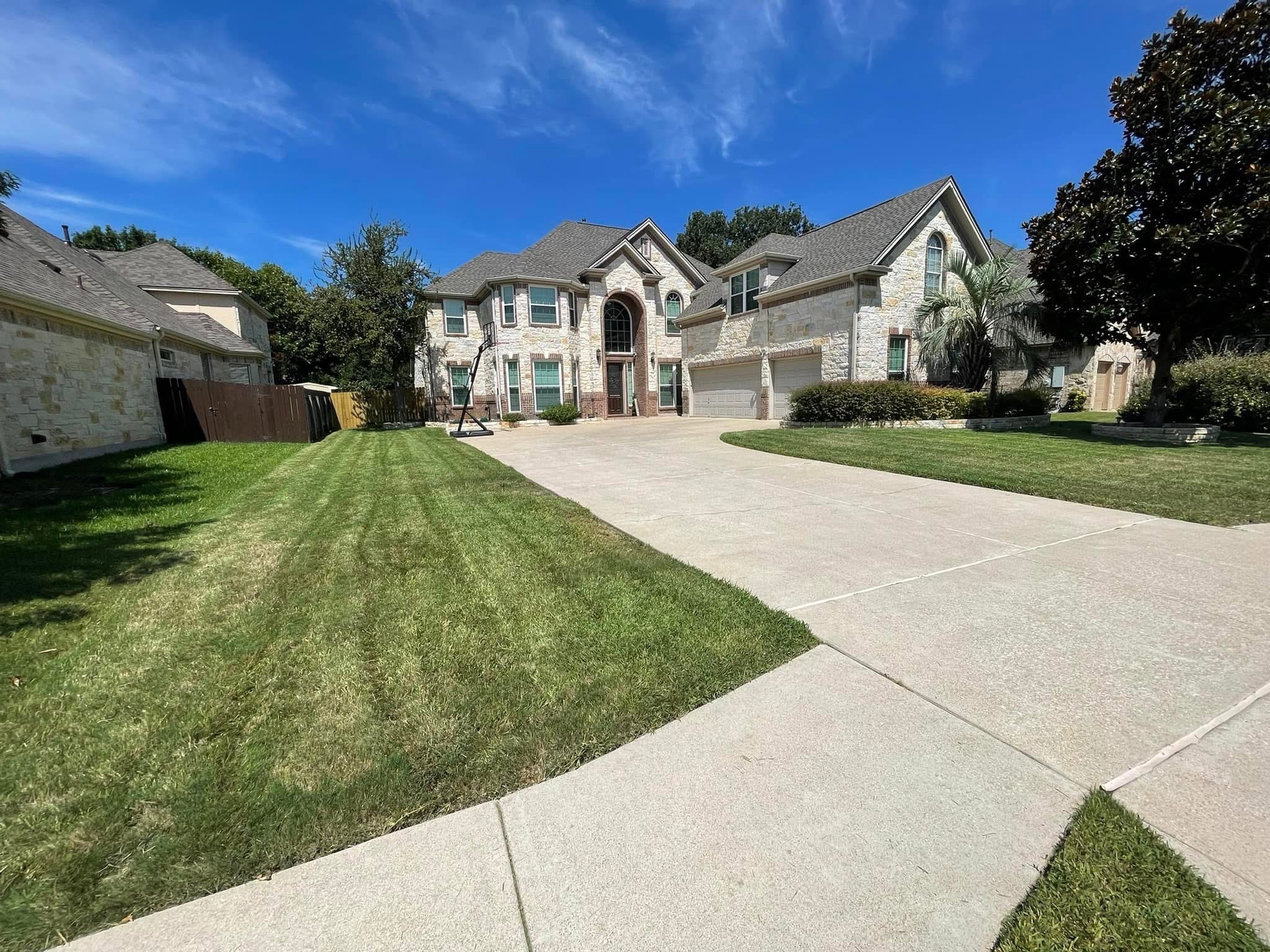 Front lawn freshly mowed along the driveway